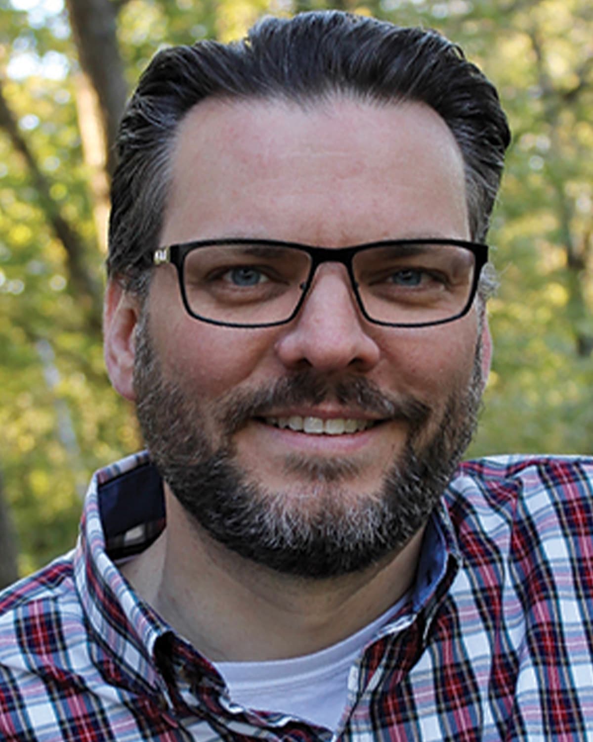 a man wearing glasses and looking at the camera a man wearing glasses and looking at the camera