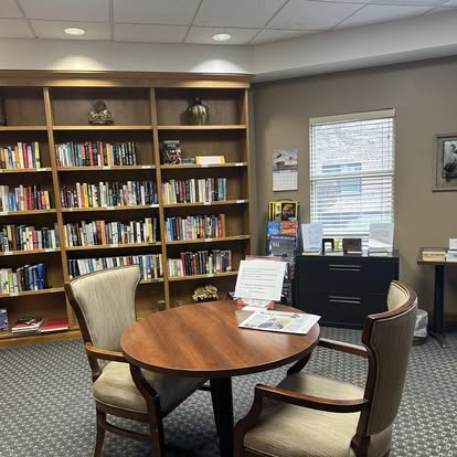 a living room with a book shelf a living room with a book shelf