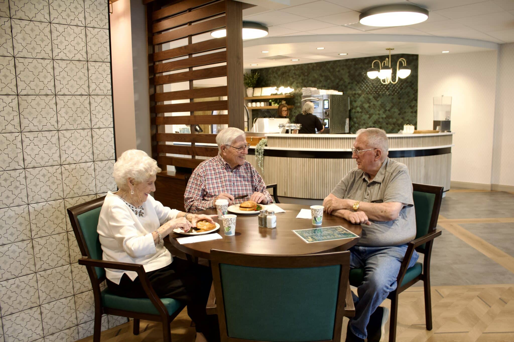 a group of people sitting at a table in a restaurant a group of people sitting at a table in a restaurant