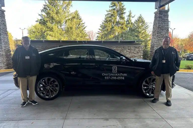 a man standing in front of a car