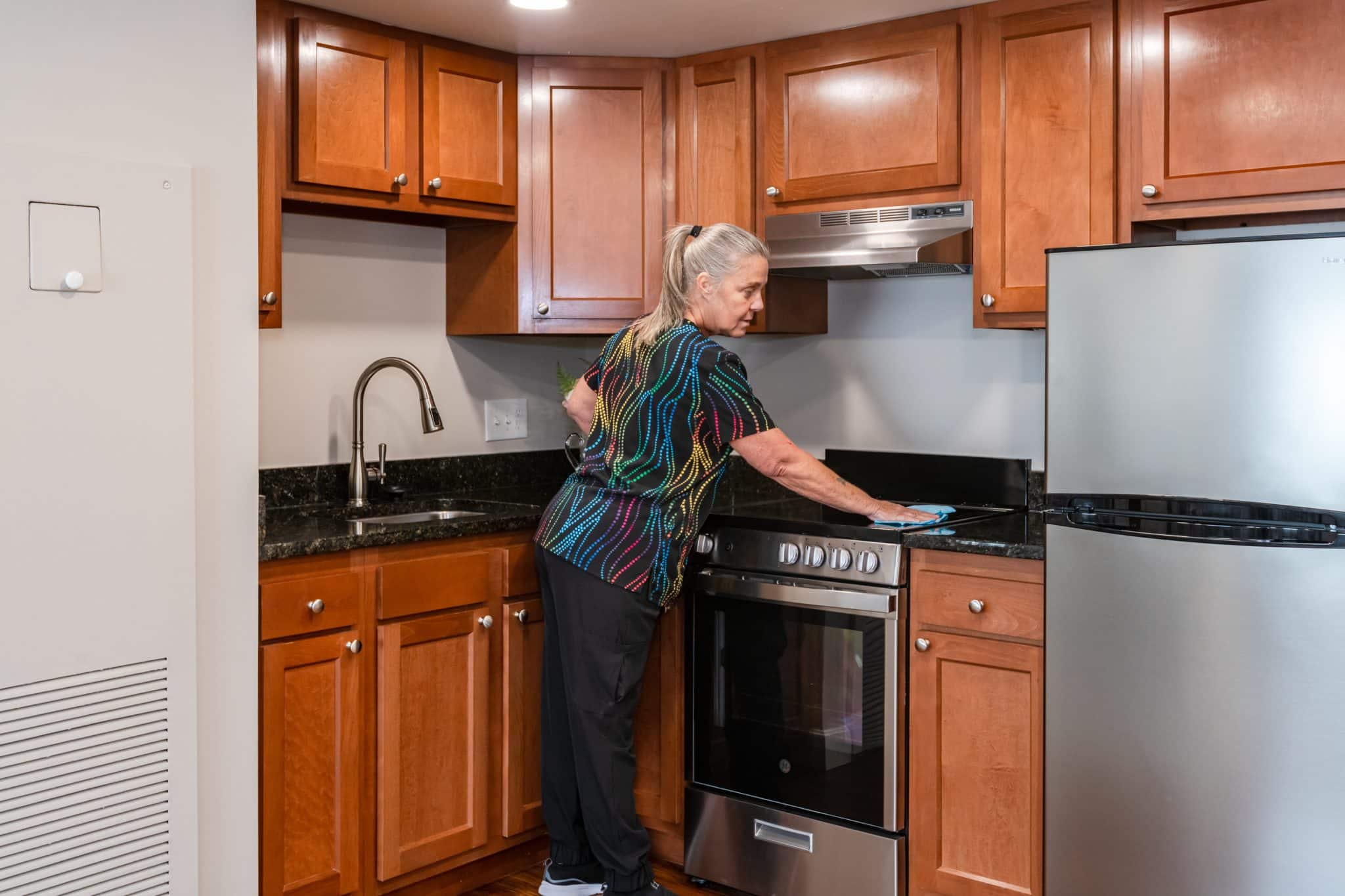 a kitchen with stainless steel appliances and wooden cabinets